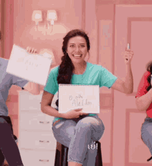 a woman holding a sign that says aladdin