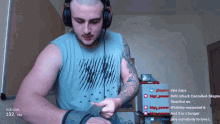 a man wearing headphones and a shirt that says under armour is playing a video game