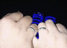 a close up of a person 's hands with rings