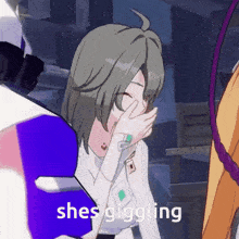 a girl covering her mouth with her hand and the words she 's giggling