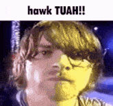 a close up of a person 's face with the words hawk tuah written above it