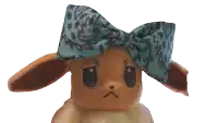 a stuffed animal with a bow on its head looks angry