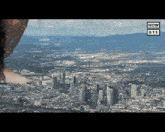 an aerial view of a city with a now gts logo in the corner