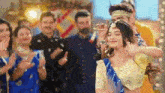 a woman is dancing in front of a crowd of people at a party .