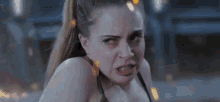 a woman is making a funny face with her mouth wide open .