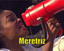a woman holding a red hair dryer with the name meretriz on the bottom right