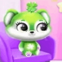 a green and white stuffed animal is sitting on a purple chair .