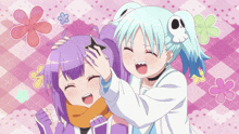 a girl with a skull on her head is playing with another girl 's hair