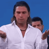 a man in a white shirt is standing in front of another man