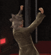 a person in a green robe has a star on the back of his jacket