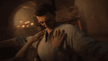 a man and a woman are touching each other 's faces in a dark room