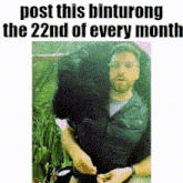 a picture of a man holding a large black bear with the caption post this binturong the 22nd of every month