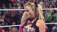 a woman in a wrestling ring is wearing a shirt that says ' n live ' on it