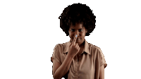 a woman with an afro is holding her nose because she has a bad smell