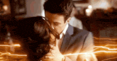 a man and a woman are kissing in front of a lightning bolt .