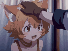 a person petting a little girl 's head with a cat 's ears