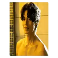 a shirtless man is standing in front of a tiled wall in a bathroom .