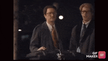 two men are standing next to each other with a gif maker app open