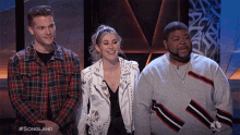 three people on a stage with the words #songland on the bottom right