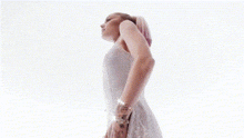 a woman with pink hair is covering her face with her hands