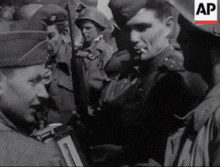 a black and white photo of a group of soldiers with ap written on the bottom