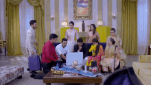 a group of people are gathered around a coffee table