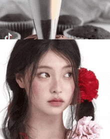a close up of a woman 's face with a flower in her hair