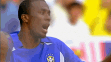 a soccer player wearing a blue shirt with the letters cbf on the front