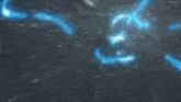 a blue light is coming out of the ground in a dark room .
