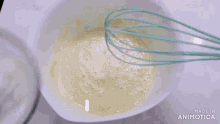 a person is pouring powdered sugar into a bowl of liquid .