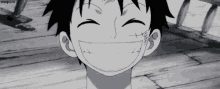 monkey d luffy from one piece is smiling in a black and white image .