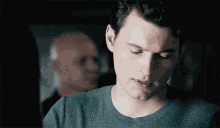 a close up of a man 's face with a blurred background of a man .