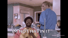 a man with a towel around his neck says i 'm not havin it in a kitchen