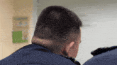 a man 's head is shown with a white board in the background with the number 10