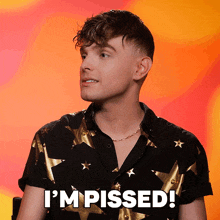 a man wearing a black shirt with gold stars and the words i 'm pissed