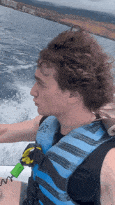 a man wearing a blue life vest with the letter a on it