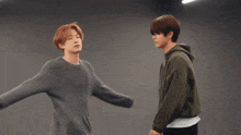 two young men are dancing together in a room