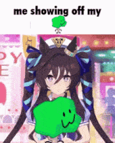 a girl with pigtails is holding a green smiley face .