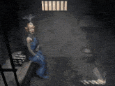 a woman is sitting in a jail cell with a toilet