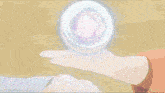 a person is holding a ball in their hand that is glowing