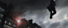 a person is flying through the air in a dark sky