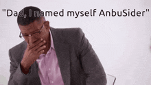 a man in a suit covering his mouth with his hand and the words " dad i named myself anbuside " behind him
