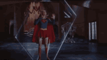 a woman in a superman costume is standing in front of a glass wall