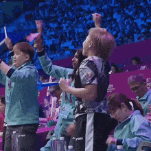 a woman wearing a lanyard that says ' yonex ' on it stands in a crowd of people