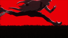 a silhouette of a person running on a grassy field with a red background