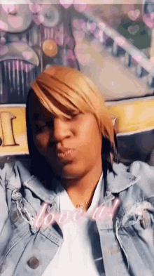 a woman wearing a denim jacket and a white shirt is sitting in a car .