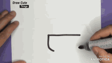 a person is drawing a rectangle on a piece of paper with a marker
