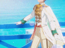 a man in a white and gold suit is standing in front of a blue ocean .