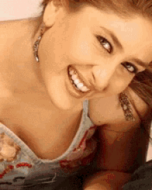 a close up of a woman 's face with a man 's face in the background