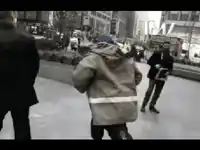 a group of people are walking down a street in front of a building that says ' the empire ' on it